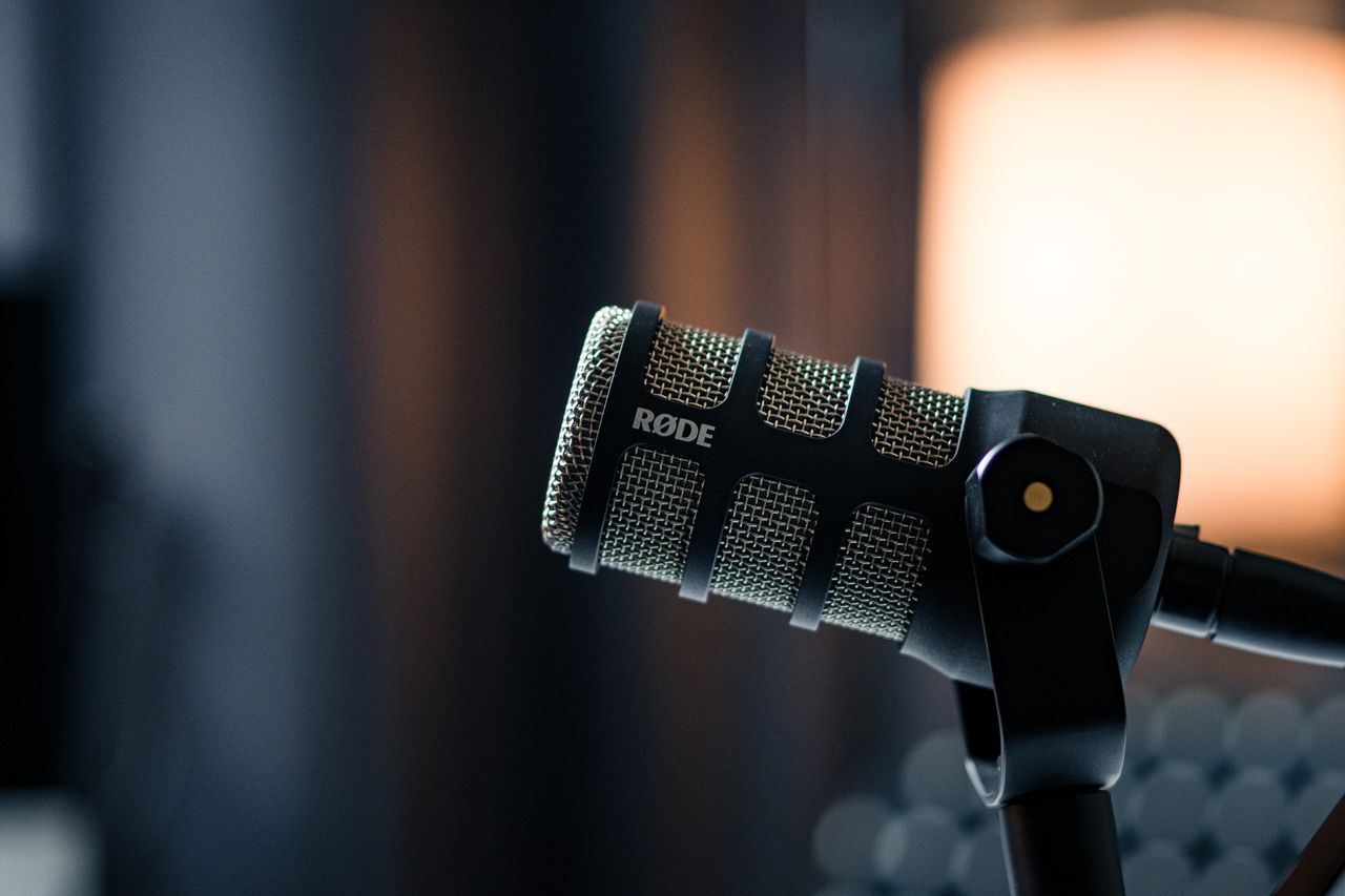 gallery-02 Close-up of a Rode microphone in a studio, emphasizing professional audio equipment.